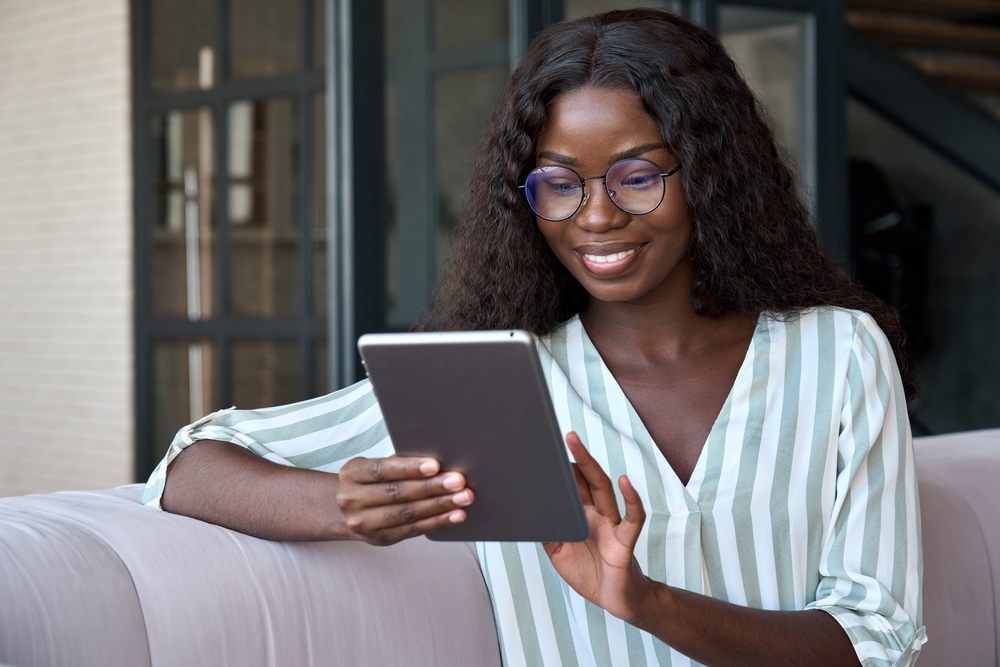 image of young black woman reading an ebook
